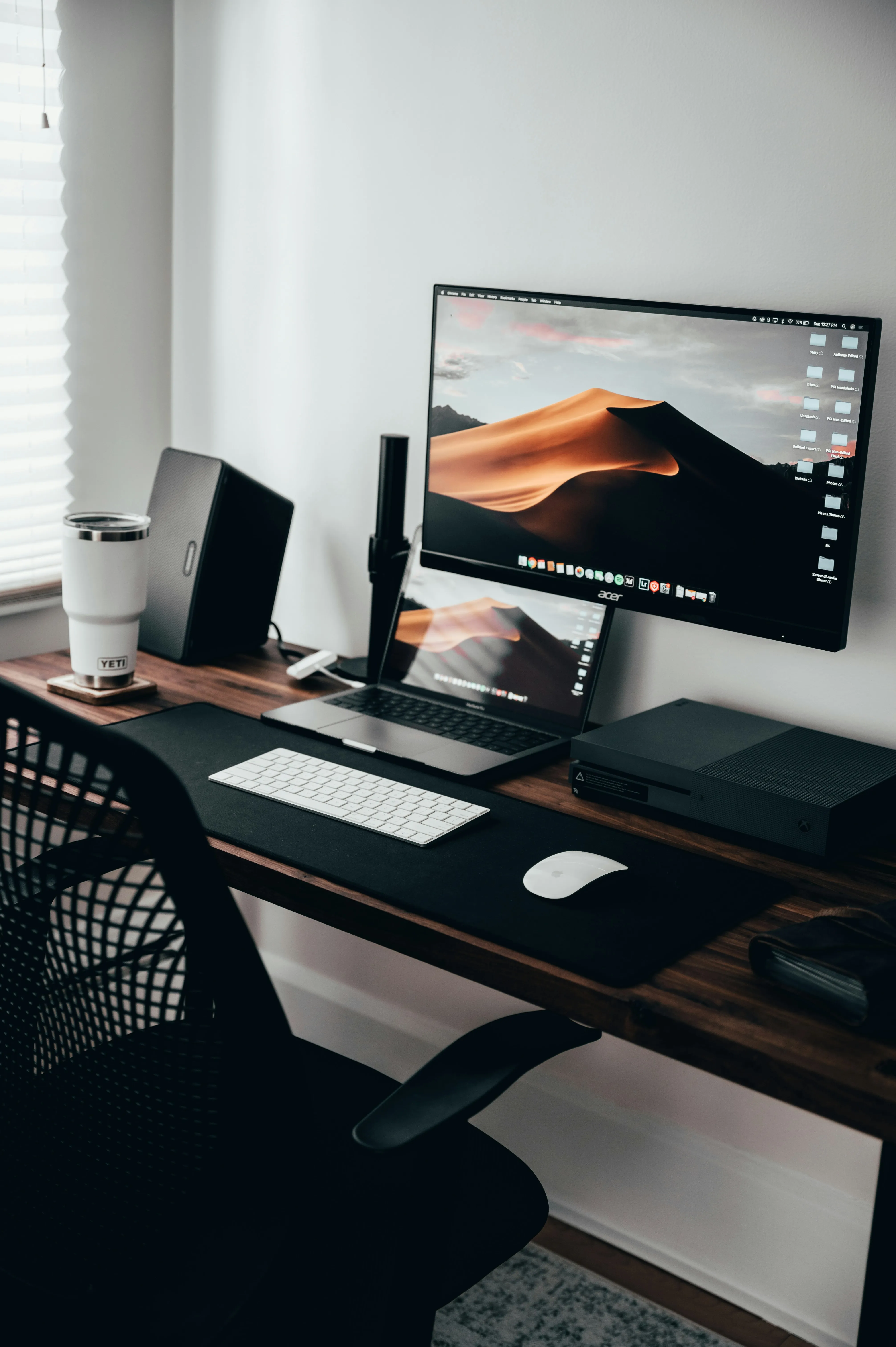 A tidy workstation with a laptop, monitor and keyboard
